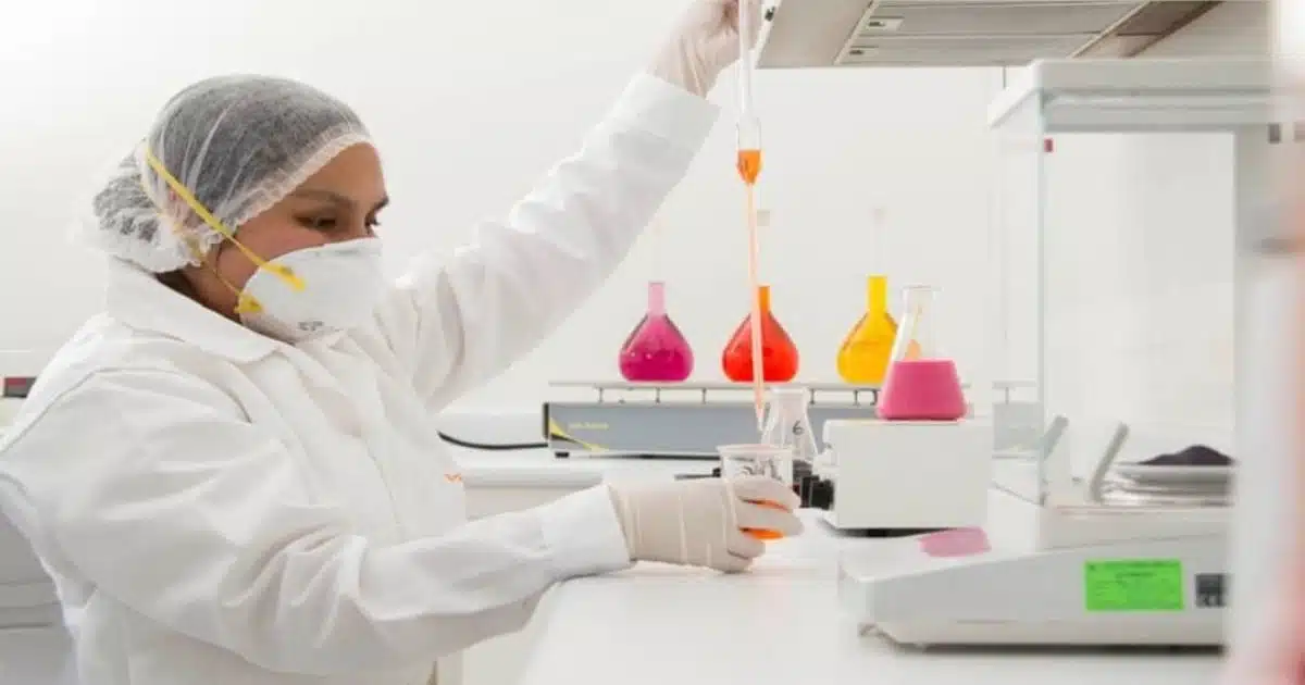 An employee at a Natural Food Color Supplier manufacturing a natural food color.